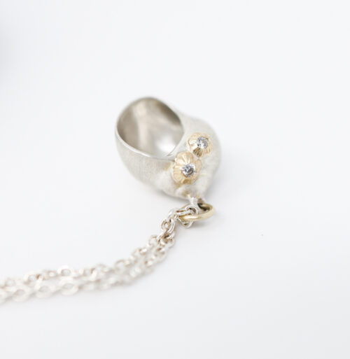 little moon snail shell necklace by Hannah Blount with diamonds and barnacles
